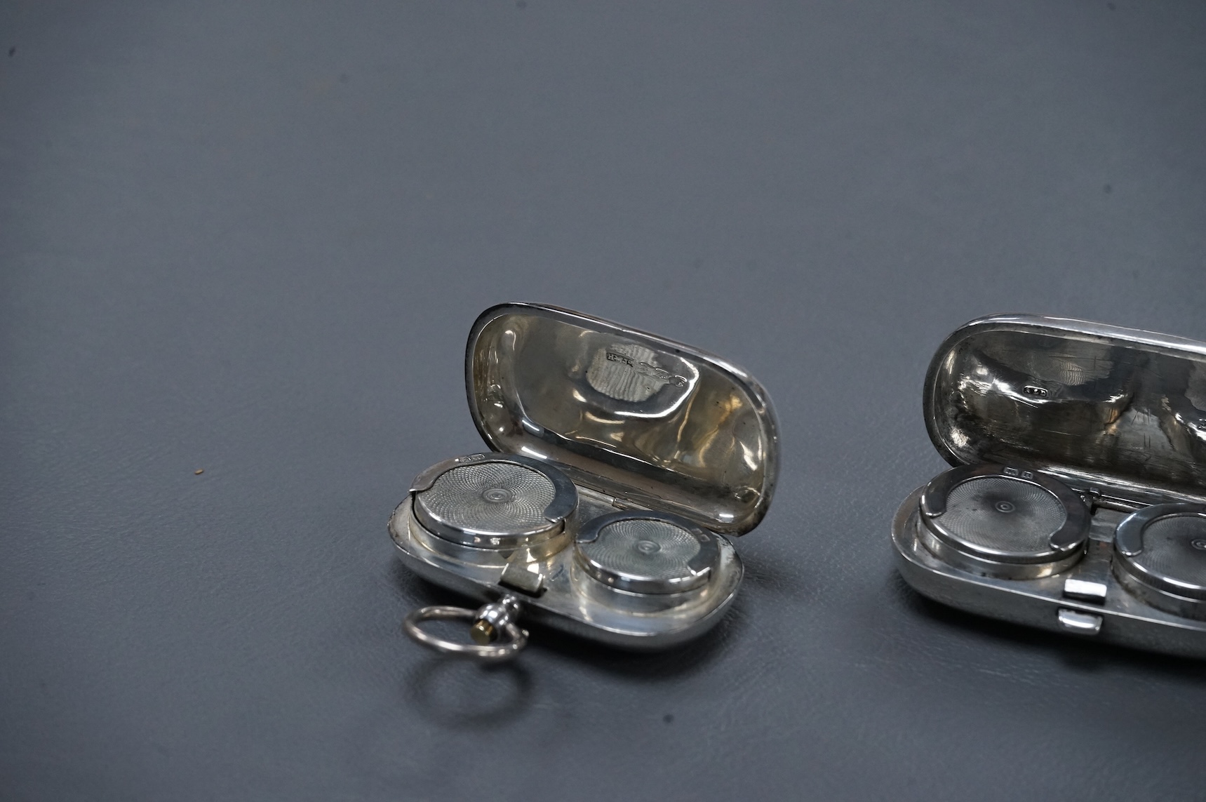 Two Edwardian twin compartment silver sovereign cases, one for sovereigns, the other for sovereign and half sovereign, both Birmingham, 1909, largest 56mm.